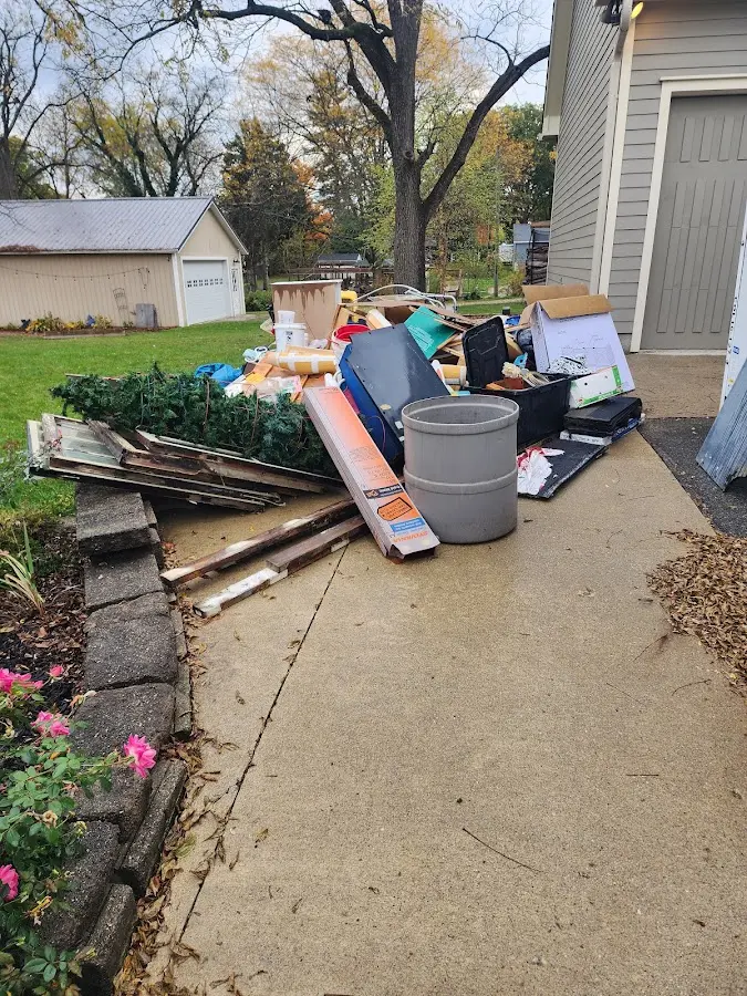Dumpster being loaded with debris for 10 Yard Dumpster Rental in Minnetrista